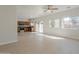 Open-concept living area showcasing tile flooring, large windows, and seamless flow into the modern kitchen at 9939 W Southgate Ave, Tolleson, AZ 85353