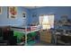 Fun bedroom featuring loft bed with play area underneath, complemented by lots of games and toys at 10036 W Chipman Rd, Tolleson, AZ 85353
