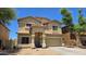 Charming two-story home featuring a welcoming front porch and a well-manicured yard at 10036 W Chipman Rd, Tolleson, AZ 85353