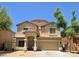 Inviting two-story home with a classic facade and a neat, low-maintenance landscape at 10036 W Chipman Rd, Tolleson, AZ 85353