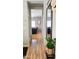 Inviting hallway with hardwood floors, leading into a spacious living area, enhanced by natural light at 10036 W Chipman Rd, Tolleson, AZ 85353