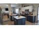 Bright kitchen featuring an island with white countertops, stainless steel appliances, and seamless flow to living space at 10036 W Chipman Rd, Tolleson, AZ 85353