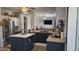 Well-lit kitchen with stainless appliances, island, dark cabinetry, and butcher block countertops; great for cooking and gathering at 10036 W Chipman Rd, Tolleson, AZ 85353