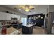 Well-lit kitchen featuring stainless steel appliances and a functional center island with a table in background at 10036 W Chipman Rd, Tolleson, AZ 85353