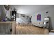 Bright living room with hardwood floors, a dining area, comfortable seating, and stylish decor at 10036 W Chipman Rd, Tolleson, AZ 85353