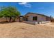 Exterior of home showcasing back patio, desert landscaping, and block wall at 10408 W Miami St, Tolleson, AZ 85353