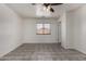 Neutral bedroom with a ceiling fan, tile floor, and a window at 10408 W Miami St, Tolleson, AZ 85353
