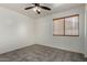 Bedroom with ceiling fan, tile floors, base molding, and a window with blinds at 10408 W Miami St, Tolleson, AZ 85353
