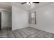 Neutral bedroom with tile floors, a window, and a ceiling fan at 10408 W Miami St, Tolleson, AZ 85353