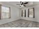 A bedroom with tile floors, ceiling fan and windows that let in natural light at 10408 W Miami St, Tolleson, AZ 85353