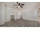 Comfortable bedroom with a ceiling fan, tile floor, and walk-in closet at 10408 W Miami St, Tolleson, AZ 85353