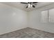 Bedroom with tile flooring, ceiling fan, and a bright window at 10408 W Miami St, Tolleson, AZ 85353
