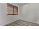 A neutral room with tile floors, a window with blinds, and base molding at 10408 W Miami St, Tolleson, AZ 85353