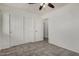 Bedroom with tile floors, closet, ceiling fan and open doorway at 10408 W Miami St, Tolleson, AZ 85353