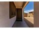 Inviting front entrance with a classic door, stylish light fixture, and low maintenance desert landscaping at 10408 W Miami St, Tolleson, AZ 85353