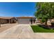 Charming single-story home with a well-manicured front yard and a spacious two-car garage at 10408 W Miami St, Tolleson, AZ 85353