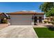 Charming single-story home with a well-manicured front yard and a spacious two-car garage at 10408 W Miami St, Tolleson, AZ 85353