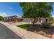 Charming single-story home with a well-manicured front yard and a spacious two-car garage at 10408 W Miami St, Tolleson, AZ 85353