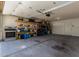 Two car garage with shelving units, open space and automatic door at 10408 W Miami St, Tolleson, AZ 85353