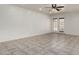 Spacious living room featuring tile flooring, recessed lighting, and access to the backyard at 10408 W Miami St, Tolleson, AZ 85353