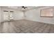 Spacious living room featuring tile flooring, recessed lighting, and access to the backyard at 10408 W Miami St, Tolleson, AZ 85353