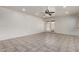 Spacious living room featuring tile flooring, recessed lighting, and access to the backyard at 10408 W Miami St, Tolleson, AZ 85353