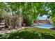 Lush backyard with artificial grass, a swimming pool and a covered patio at 11253 E Peterson Ave, Mesa, AZ 85212