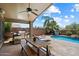 Spacious backyard with a covered patio, pool, outdoor kitchen, and lounge chairs at 11253 E Peterson Ave, Mesa, AZ 85212