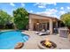 Outdoor oasis with pool, fire pit, BBQ, lounge chairs, and a covered patio at 11253 E Peterson Ave, Mesa, AZ 85212