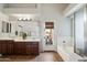 Bathroom featuring double sinks, vanity, bathtub, and access to a patio at 11253 E Peterson Ave, Mesa, AZ 85212