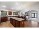 Open-concept kitchen with a granite countertop island, stainless steel appliances, and seamless dining area at 11253 E Peterson Ave, Mesa, AZ 85212