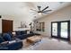 Comfortable living room featuring a ceiling fan, plenty of natural light, and modern decor at 11253 E Peterson Ave, Mesa, AZ 85212