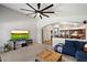 Comfortable living room featuring a large television, seamless access to the kitchen, and modern decor at 11253 E Peterson Ave, Mesa, AZ 85212