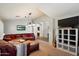 Spacious living room featuring a comfortable leather sofa and ample natural light at 11253 E Peterson Ave, Mesa, AZ 85212