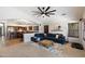 Cozy living room featuring a large sectional sofa, ceiling fan, and seamless access to the kitchen at 11253 E Peterson Ave, Mesa, AZ 85212