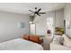 Bright bedroom with a ceiling fan, seating area, and access to other rooms at 11253 E Peterson Ave, Mesa, AZ 85212