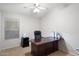 Bright home office with a large desk, comfortable chair, and ample workspace at 11253 E Peterson Ave, Mesa, AZ 85212