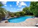 A tranquil swimming pool surrounded by lush greenery and rock accents at 11253 E Peterson Ave, Mesa, AZ 85212