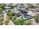 Aerial view of pool in landscaped backyard with patio and two-story home at 11965 W Monte Vista Rd, Avondale, AZ 85392
