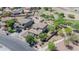 Aerial view of a desert home and well-maintained landscaping with two-car attached garage and a paved driveway at 11965 W Monte Vista Rd, Avondale, AZ 85392