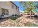 Expansive backyard with lush grass, mature tree, and outdoor kitchen and bar at 11965 W Monte Vista Rd, Avondale, AZ 85392