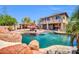 Expansive backyard features a pool, outdoor kitchen with bar, and a dining area, perfect for entertaining guests at 11965 W Monte Vista Rd, Avondale, AZ 85392