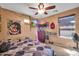 Charming bedroom with an eclectic style with string lights and a unique geometric duvet cover at 11965 W Monte Vista Rd, Avondale, AZ 85392