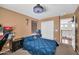 Comfortable bedroom featuring a blue patterned duvet cover and a contemporary ceiling fan at 11965 W Monte Vista Rd, Avondale, AZ 85392