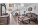 Elegant living room with two-story ceiling, dark wood accents, and tile flooring at 11965 W Monte Vista Rd, Avondale, AZ 85392
