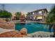 Stunning backyard with a large pool, rock features, and an outdoor lounge area at 11965 W Monte Vista Rd, Avondale, AZ 85392