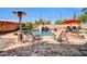 Backyard features a sparkling pool, rock waterfall, outdoor dining, and a fire pit, creating the ultimate retreat at 11965 W Monte Vista Rd, Avondale, AZ 85392