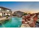Resort-style pool with rock slide and waterfall, perfect for outdoor entertainment at 11965 W Monte Vista Rd, Avondale, AZ 85392