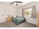 Inviting bedroom with large windows, soft lighting, ceiling fan and dresser storage at 1209 W Colter St, Phoenix, AZ 85013