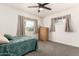 Cozy bedroom with gray carpet, neutral walls, and two windows overlooking a well-maintained lawn at 1209 W Colter St, Phoenix, AZ 85013